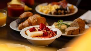 a table topped with plates of food with desserts at Radisson Blu Hotel Olümpia in Tallinn