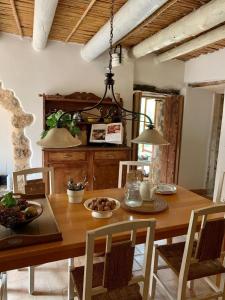 a dining room with a wooden table and chairs at Can Peñes in Port d'Andratx