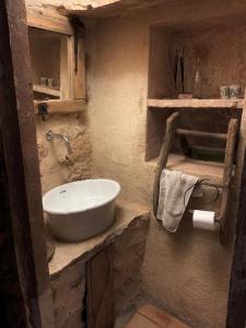 a bathroom with a white sink in a room at Can Peñes in Port d'Andratx