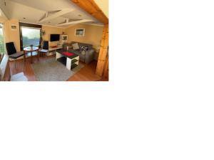 a living room with a couch and a table at Tensings Bungalow in Vitte +2 photos