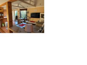 a view of a living room and a dining room at Tensings Bungalow in Vitte