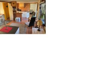 a living room and a kitchen with a table at Tensings Bungalow in Vitte