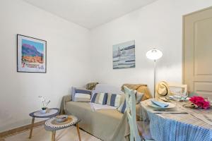 a living room with a couch and a table at Gite Chez Sophie in Roquebrune-sur-Argens
