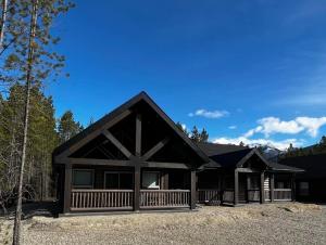a large log cabin with a gambrel roof at Whispering Pines Cabin in Valemount