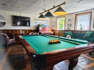 a billiard room with a pool table and a couch at First Hotel Bengtsfors in Bengtsfors +30 photos