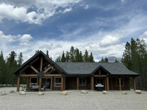a large log cabin with a roof at Polar Den Cabin in Valemount