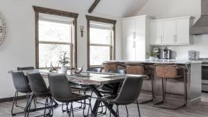 a kitchen with a table and chairs in a kitchen at The Highmark Cabin in Valemount