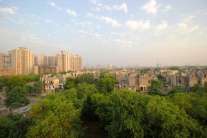 a view of a city with tall buildings and trees at Hotel O Staysnap in Indirapuram