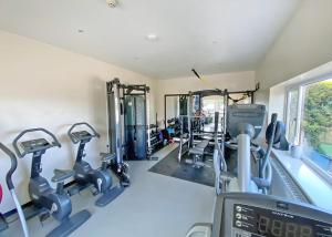 a gym with treadmills and elliptical machines at Bryn Awel Caravan Park in Pentraeth