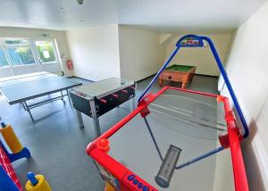a play room with a table and a trampoline at Bryn Awel Caravan Park in Pentraeth