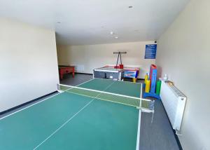 a tennis court with a net in a room at Bryn Awel Caravan Park in Pentraeth