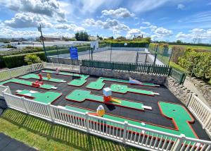 an aerial view of a playground with a tennis court at Bryn Awel Caravan Park in Pentraeth +48 photos