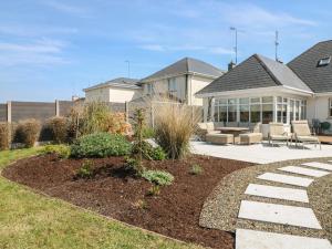 a house with a patio with chairs and a yard at Sunnyside in Riverchapel