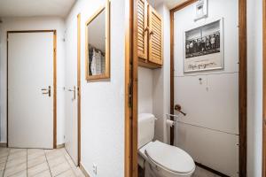a bathroom with a white toilet in a room at Appartement vue montagne - Chatel in Châtel