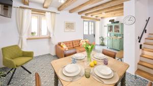 a living room with a table and a couch at Casa Pove by Villas Guide in Donje Baredine