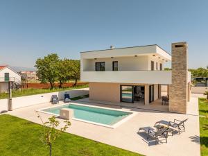 an image of a house with a swimming pool at Villa Antonio ZadarVillas in Nin