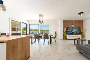 a kitchen and living room with a table and chairs at Villa Antonio ZadarVillas in Nin