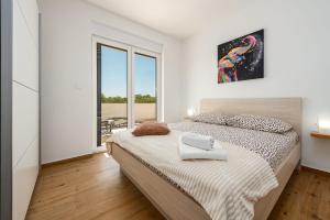 a white bedroom with a large bed and a window at Villa Antonio ZadarVillas in Nin +36 photos