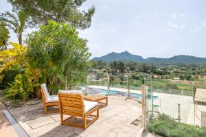 a patio with chairs and a view of a pool at Ca'n Cristofal in Felanitx