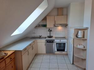 a kitchen with a sink and a stove at Ferienwohnung Morgenstern in Ausacker +18 photos