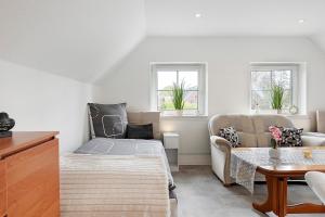 a living room with a bed and a couch at Süße kleine Wohnung in Eggstedt