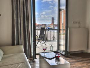 a living room with a view of a balcony at Ohlerich Speicher App_ 02 in Wismar