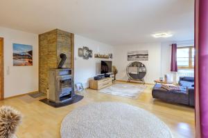 a living room with a couch and a fireplace at Freigeist in Nesselwang