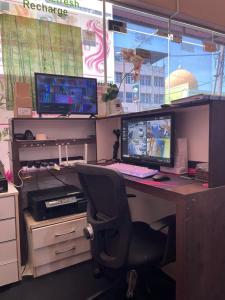 an office with a desk with two monitors and a chair at Hotel O D'noor in Kota Bharu +16 photos