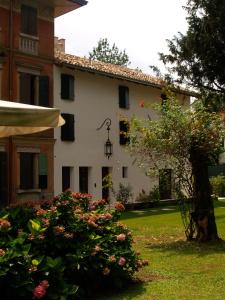 a building with a clock on the side of it at Ca' Marsure B&B in Azzano Decimo