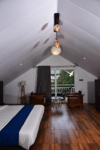 a bedroom with a bed and a large window at GOLDEN GREEN RESORT WITH Pool in Munnar +46 photos