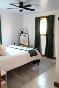 a bedroom with a bed and a ceiling fan at Pondside Abode in Dundee