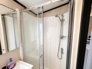 a shower stall in a bathroom with a sink at Prins Chalets Hoogersmilde Drenthe in Hoogersmilde +34 photos