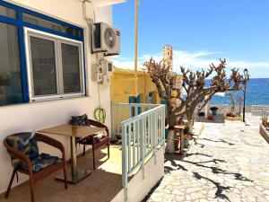 a balcony with a table and chairs and the ocean at Maria Mare in Myrtos +13 photos