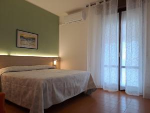 a bedroom with a bed and a window at B&B Locanda Al Pontesel in Garda +13 photos