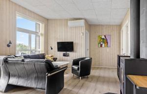 a living room with a couch and a chair at Awesome Home In Haderslev With Sauna in Haderslev