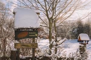 a sign in the snow next to a tree at Na Wysokiej Górce- Agroturystyka in Grabowiec +34 photos