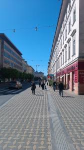 a group of people walking down a city street at CoCo Apartment in Ljubljana +1 photo