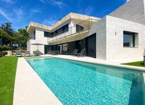 a house with a swimming pool in front of it at Naramia Sagaro Villa - with Pool-garden-10 Pax in S'agaro