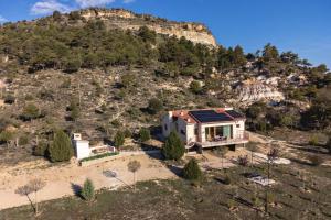 an aerial view of a house with a mountain in the background at Casa Rural Terranova Luxe in Buenache de la Sierra