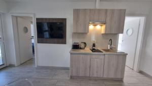 a kitchen with a sink and a counter top at Srebrna Wydma in Dąbki