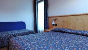 Postel nebo postele na pokoji v ubytování Hotel Giardino