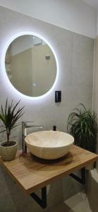 a bathroom with a large bowl sink on a wooden table at Lighthouse Zadar Center Apartments in Zadar