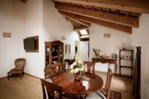 a dining room with a wooden table and chairs at Villa Bido in Anguillara Veneta