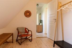 a room with a chair and a table at Atma Guesthouse - cozy and simple farmhouse bed & breakfast in Marstal +21 photos