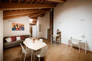 a living room with a couch and a table and chairs at Villa Bido in Anguillara Veneta