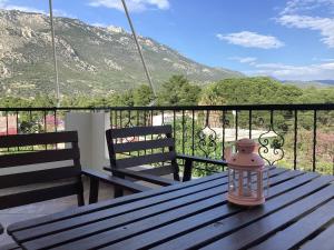 a lantern sitting on a wooden table on a balcony at Soft Horizon Apartment in Loutraki