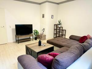 a living room with two couches and a flat screen tv at Charmante Wg im Stadtgeflüster in Schwäbisch Hall