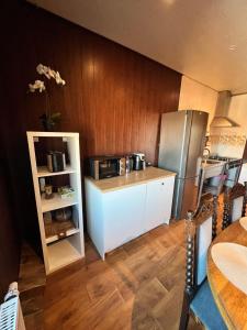 a small kitchen with a refrigerator and a table at Rüütli kodumajutus in Paide +19 photos