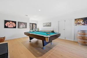 a room with a pool table and a barrel at Snowline - Ultimate Getaway, Pool, Spa & Tennis in Canobolas