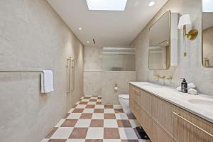 a bathroom with a toilet and a sink at Snowline - Ultimate Getaway, Pool, Spa & Tennis in Canobolas
